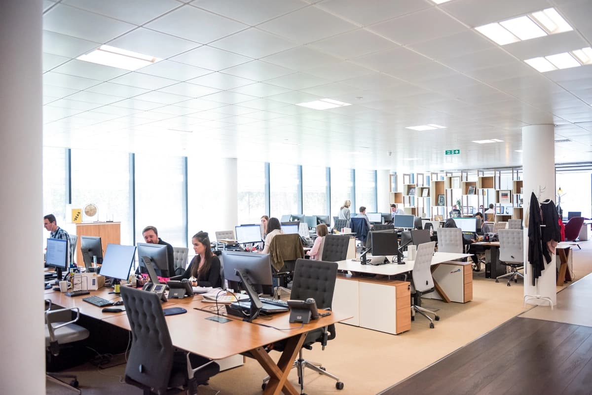 Telemarketers hard at work in the office. Learn the answer to the question "What is telemarketing?" in this post from FiveCRM.